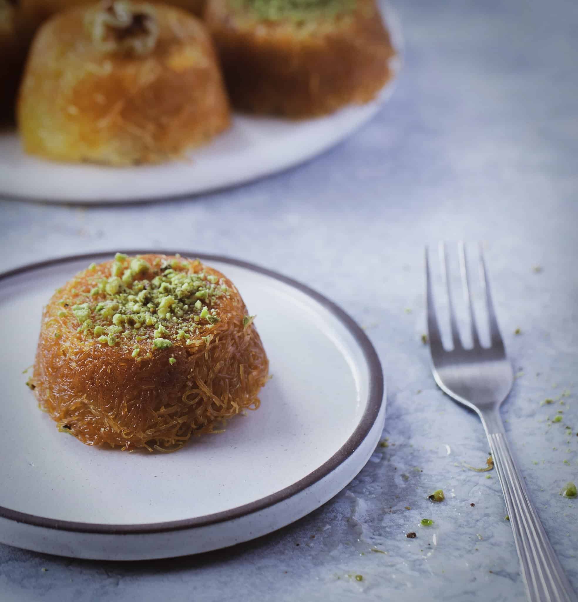 knafeh cupcake on a plate with a fork