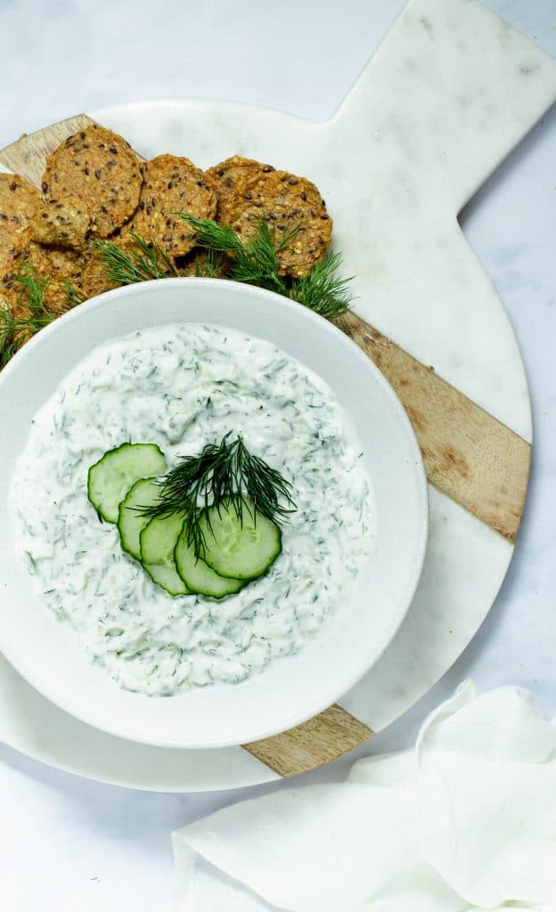 tzatziki dip on round cutting with crackers