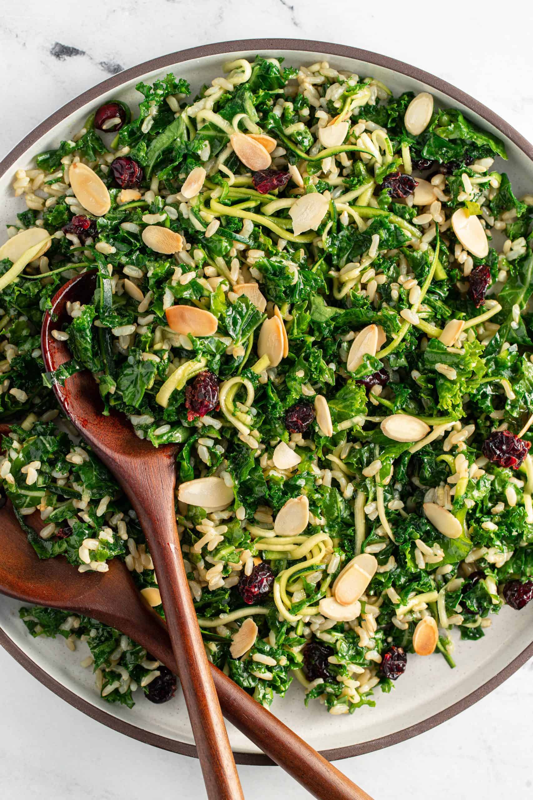 A plate of Winter Kale & Rice Salad with serving spoons