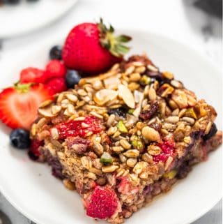 Two white plates with berry baked oatmeal