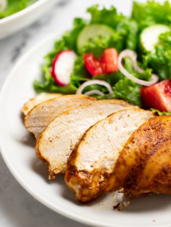 Oven baked Shawarma chicken breast on a plate with salad